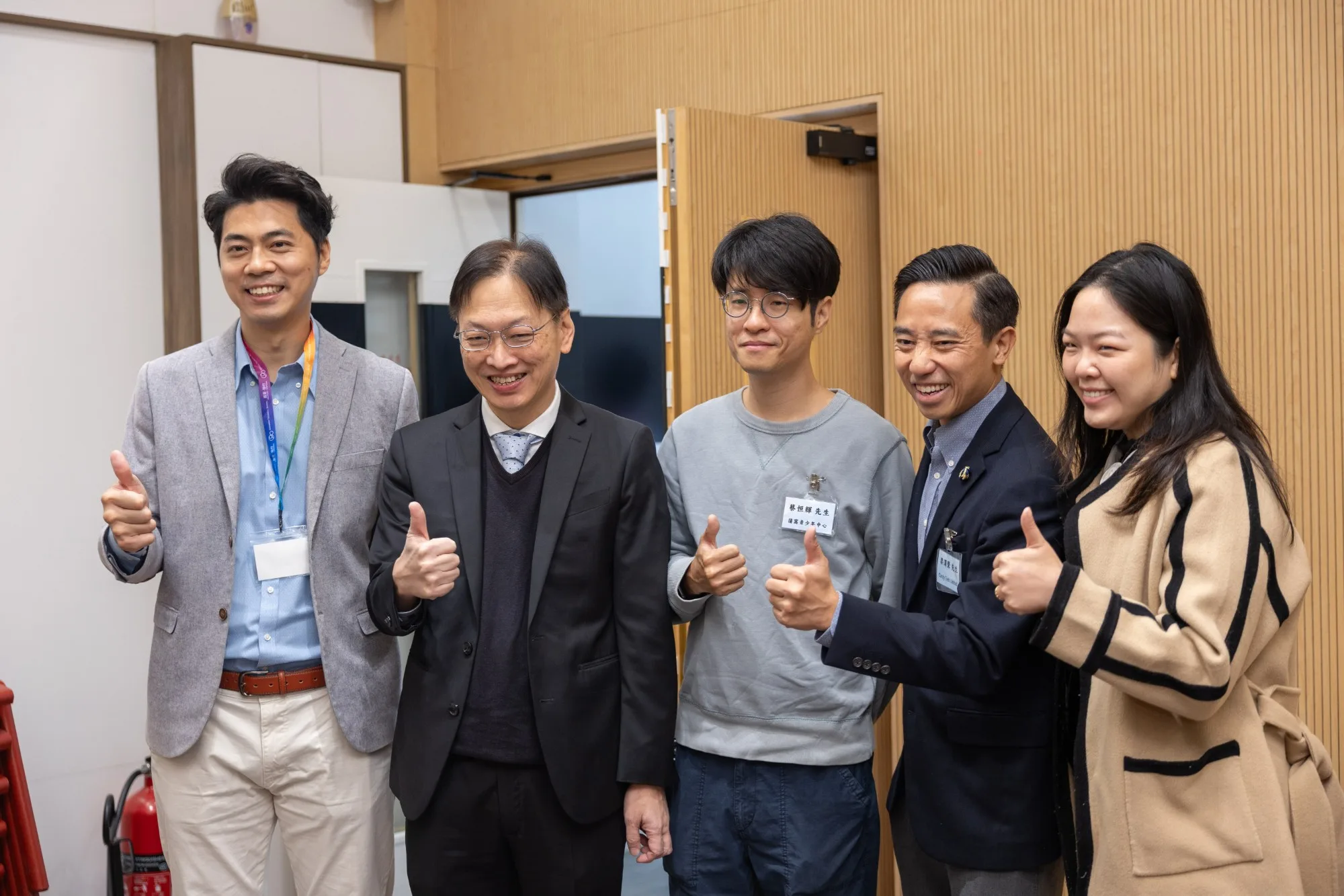 Five members of the Cardy Tech team and its partners pose for a group photo at the venue, each giving a thumbs-up